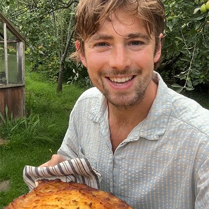 Julius Roberts holding a shepherds pie in a garden